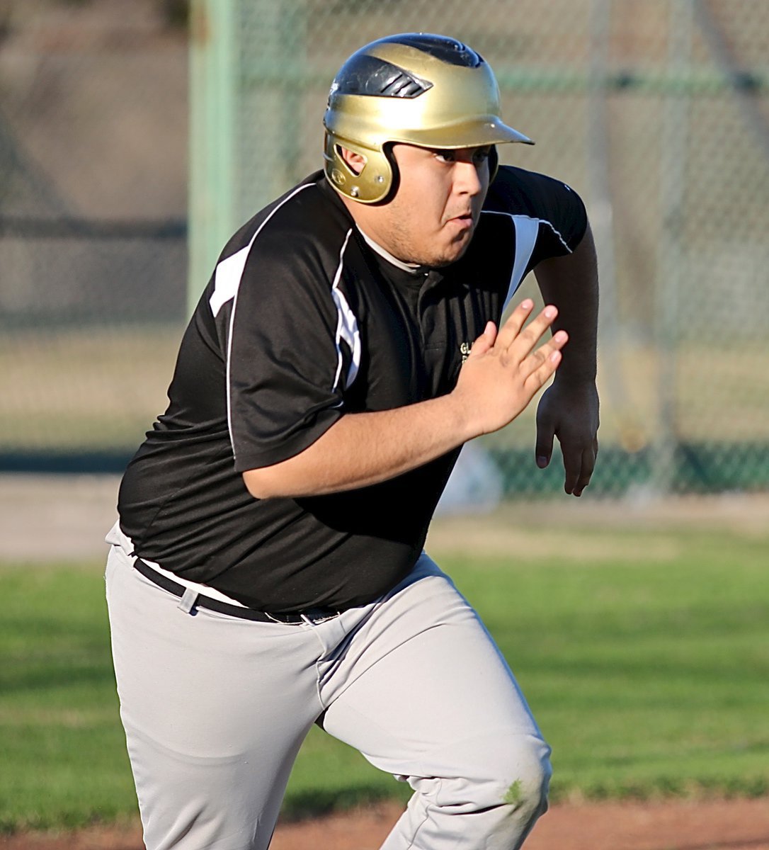 Image: Gladiator Pedro Salazar hits and then storms down the first-base line.