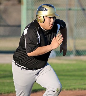 Image: Gladiator Pedro Salazar hits and then storms down the first-base line.