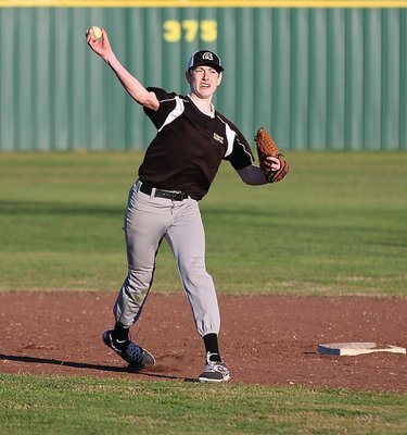 Image: Italy’s Clayton Miller warms up between innings at short.