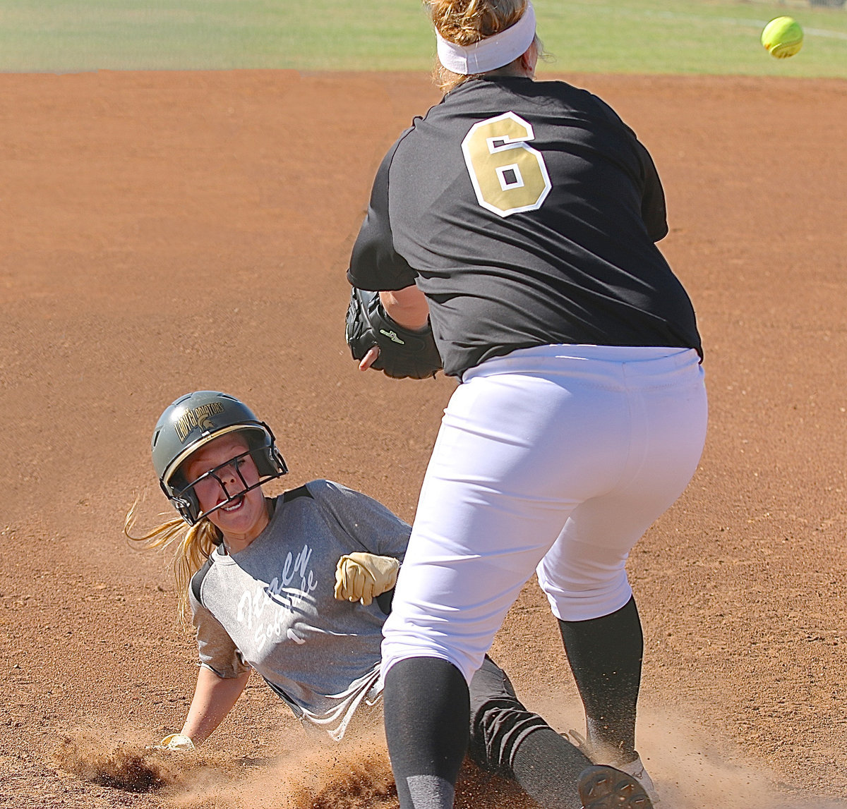 Image: Italy’s Bailey Eubank(1) slides into third-base beating the throw by Palmer.