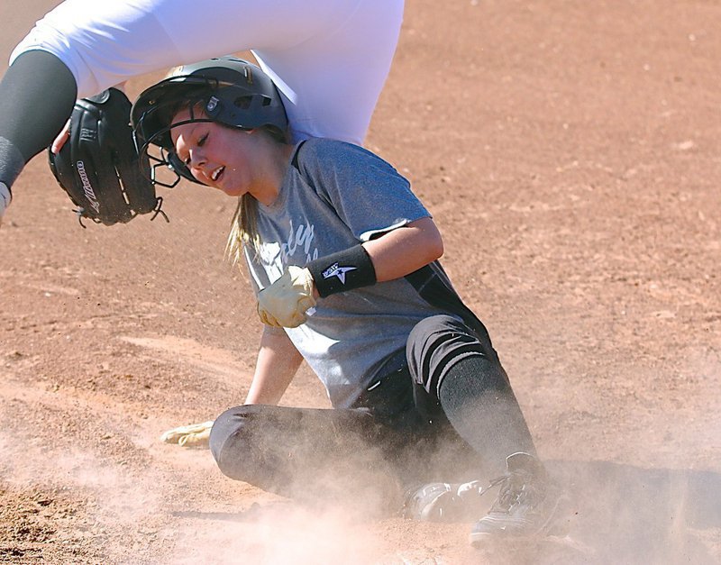 Image: After nearly loosing her war bonnet, Bailey Eubank(1) scrambles to her cleats and hurries home for a Lady Gladiator run.