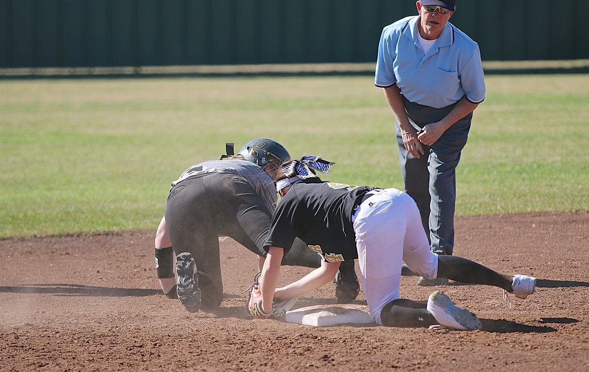 Image: Madison Washington(10) keeps her leg extended and her tootsies touching for a safe call after sliding across second-base.