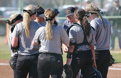 Image: Lady Gladiator assistant coach Johnny Jones talks things over with his infielders.