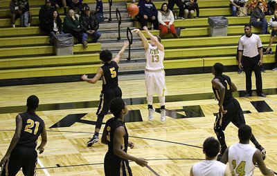 Image: Senior Gladiator John Escamilla(13) closes out the first-half by dropping in this long-range three bomb against Itasca. The shot tied the contest 25-25 at intermission.