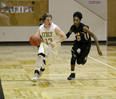 Image: Italy’s John Escamilla(13) is on a mission as he scans the court while handling the ball.