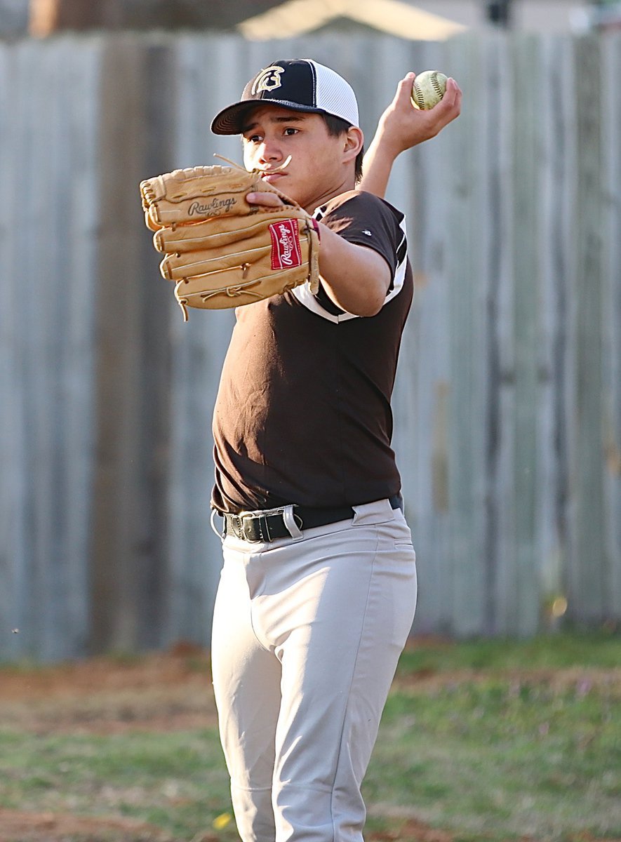 Image: Joe Celis warms up behind the dugout before entering the scrimmage.