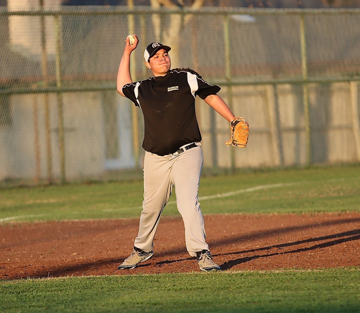 Image: Nick Kirton warms up at third-base for the Gladiators.