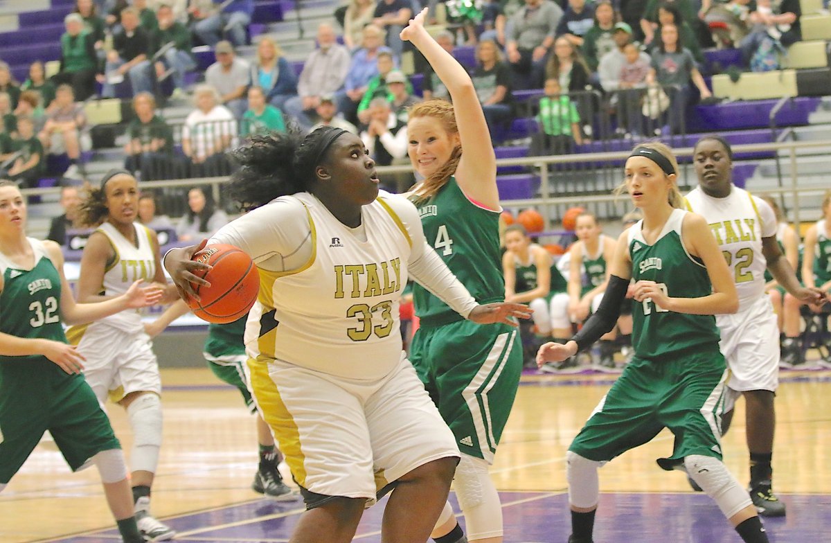 Image: Italy junior Cory Chance(33) drives to the basket early against a Santo Lady Cat defender as both team’s tangled for the 2A Region 2 Area Championship. The game was hosted at Chisholm Trail High School in Ft. Worth.