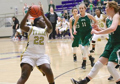 Image: Taleyia Wilson(22) rebounds a missed free throw for the Lady Gladiators.