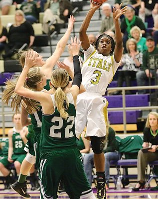Image: Italy’s Kortnei Johnson(3) rises over three Santo Lady Cats to get a jumper up and away.