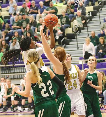 Image: Italy’s Kortnei Johnson(3) Charges to the hoop against Santo with teammate Lillie Perry(24) in good rebounding position.