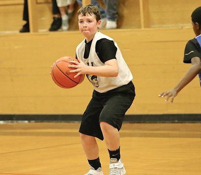 Image: Bryce DeBorde(5) searches for an open teammate. The IYAA 5th-6th grade boys defeated Whitney 30-19 inside the old Italy gym.