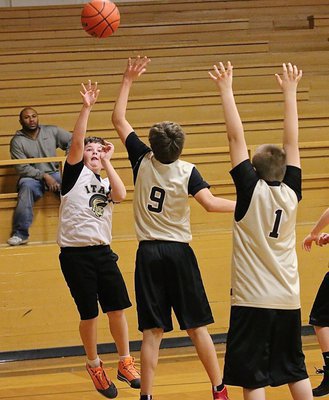 Image: Gage Wafer(4) jumps into a jumper from the right wing for Italy White. Grant Hamby(9) and Brian Haake(1) were defending for Italy Gold.