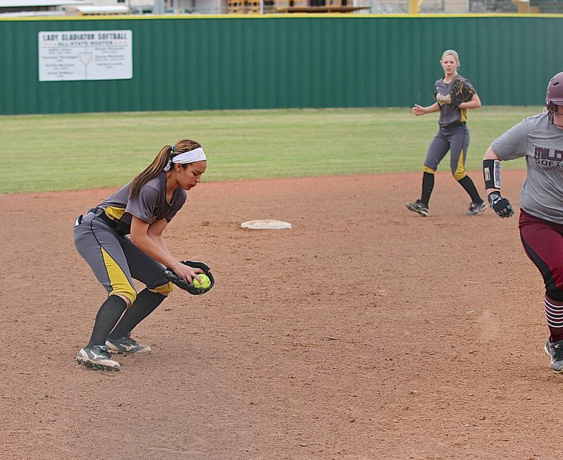 Image: Italy shortstop April Lusk(7) secures a grounder and then throws to first-base for an out against Mildred.