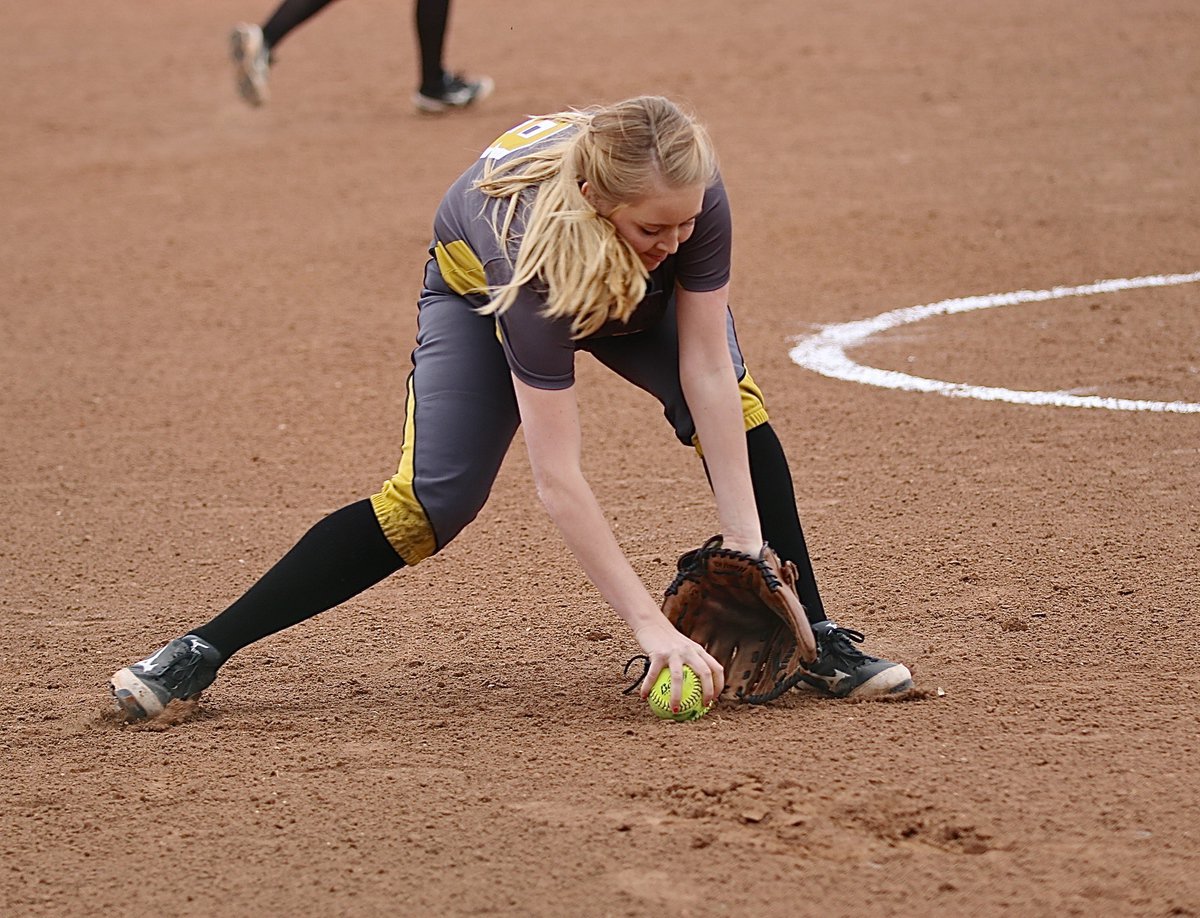 Image: Lady Gladiator third-baseman Hannah Washington(8) fields a grounder in the slippery sands.