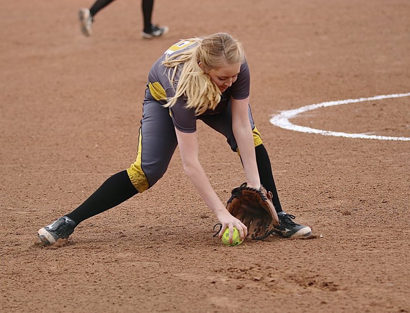 Image: Lady Gladiator third-baseman Hannah Washington(8) fields a grounder in the slippery sands.