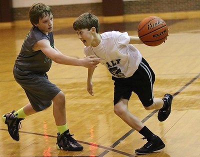 Image: Driving to the basket is Italy’s Kort Holley(2).