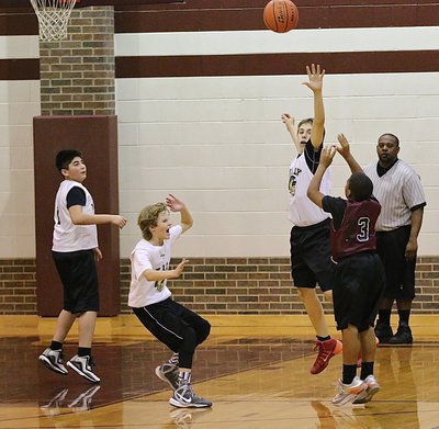 Image: Grant Hamby(9) gets a hand up on defense, Reese Janek(12) scares everybody and Andrew Celis(1) gets into position for the rebound.