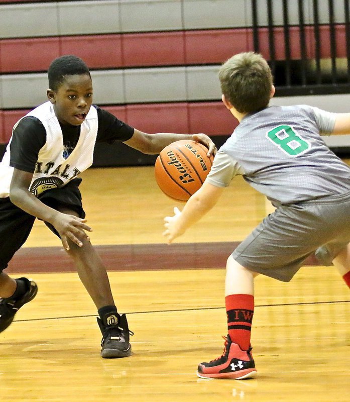 Image: Italy guard Julius Williams(15) shakes-n-bakes a Clifton defender.