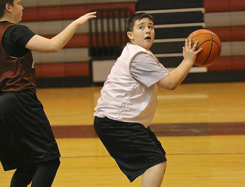 Image: Italy’s Rocklin Ginnett(5) rebounds the ball and then looks for the hoop.