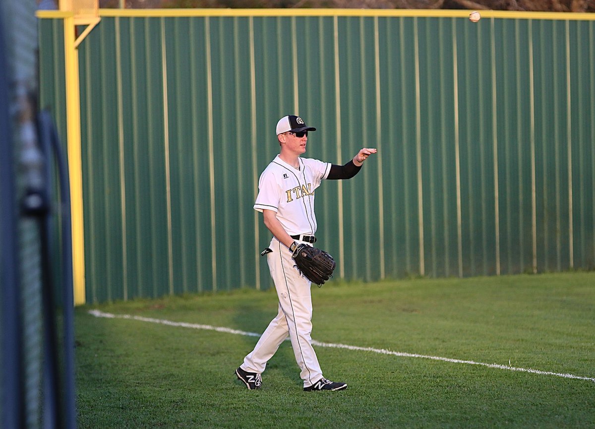 Image: Senior Gladiator left fielder Cody Boyd(10) collects a foul ball.