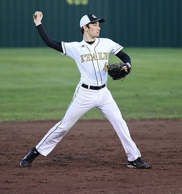 Image: Junior Gladiator Ryan Connor(4) stays loose at shortstop between innings.