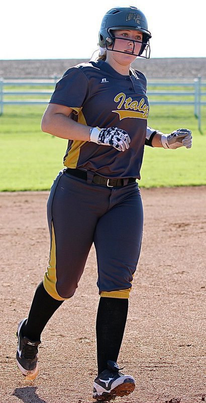Image: Italy’s Jaclynn Lewis(15) rounds third-base and heads home after her big swat over the centerfield fence.