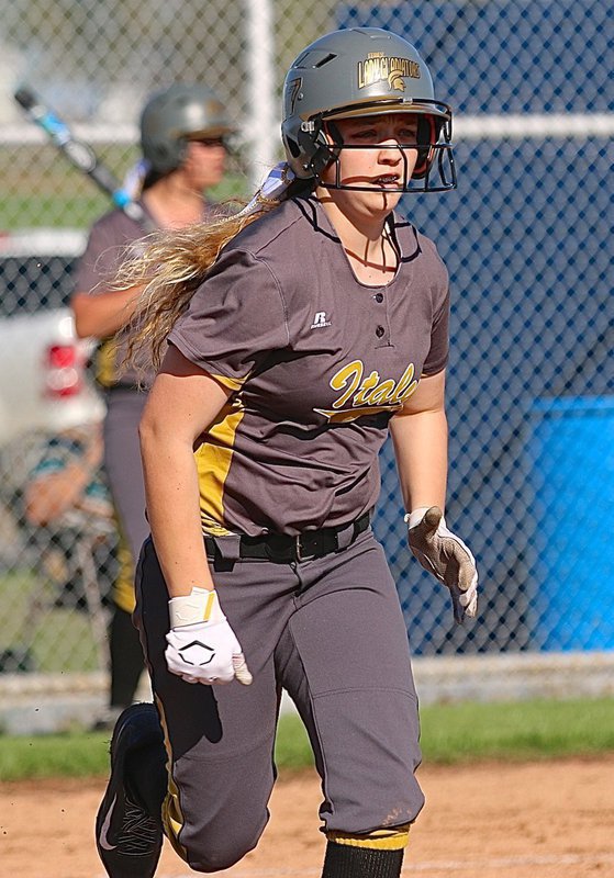 Image: Freshman Brycelen Richards(17) hurries to first-base after knocking the ball into play for Italy.