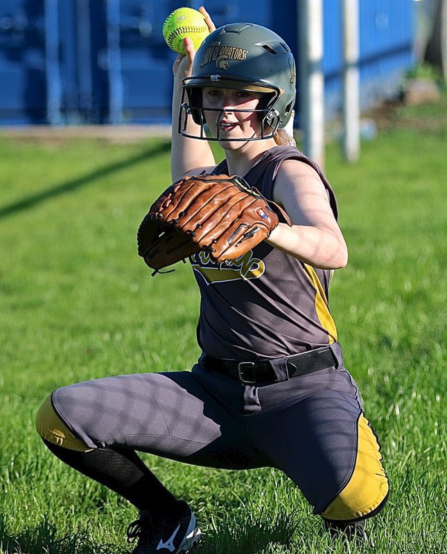 Image: Senior Kelsey Nelson(14) warms up relief pitcher Jenna Holden, just in case.