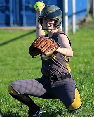 Image: Senior Kelsey Nelson(14) warms up relief pitcher Jenna Holden, just in case.
