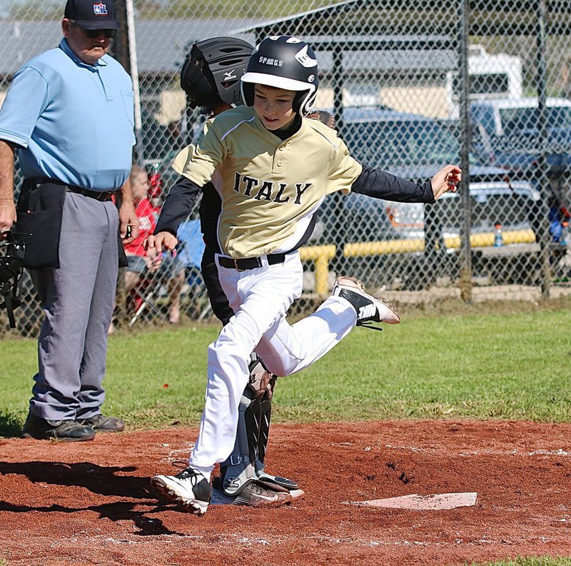 Image: Italy’s Taylor Sparks scores a run for his team.
