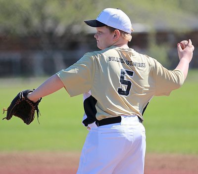 Image: First-baseman Bryce Ballard warms up the infielders between innings.