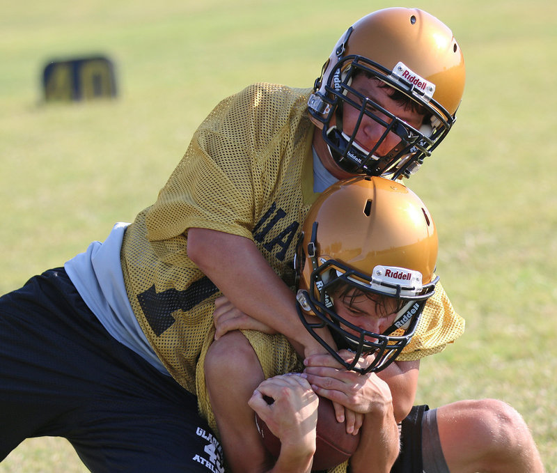 Image: Micah Escamilla(75) attempts to strip the ball from Garrett Janek.