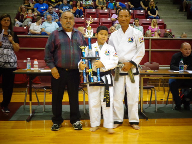 Image: Nick Sam, attends Italy ISD and has earned his first, 3 foot trophy after earning two 4 foot trophies in the past years.
    Pictured is Master Charles Kight, chief instructor of the Hillsboro TKD school, Nick and Grand Master Park co-founder of Unified TKD.
