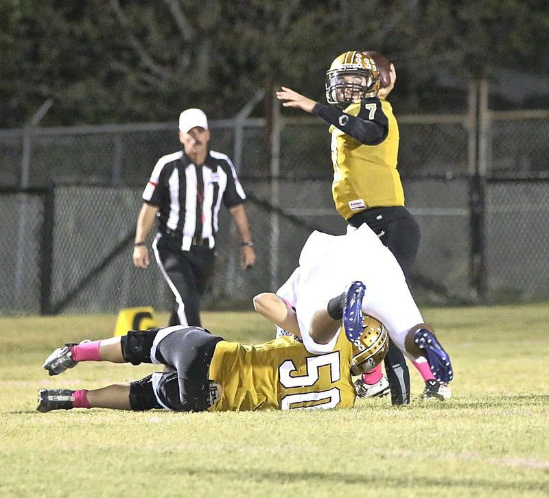 Image: Offensive guard Clay Riddle(50) cuts down a Pirate to give his QB, Ryan Connor(7) extra time to deliver a pass downfield.