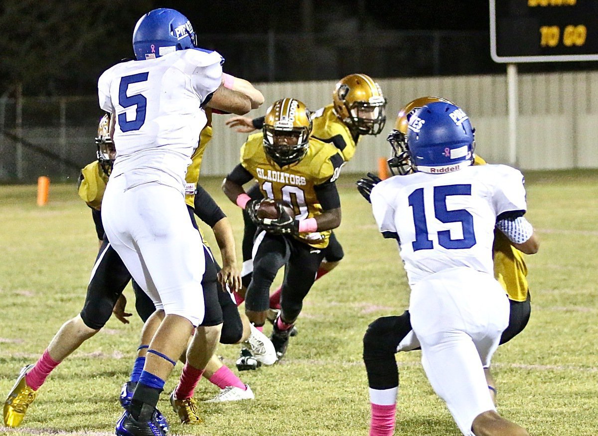 Image: Gladiator Kendrick Norwood(10) looks for some daylight under the Friday night lights at Willis Field in Italy.