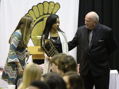 Image: Coaches Holly Bradley and Johnny Jones present T’Keya Pace with the Cross-Country MVP Award with her name engraved on the plaque.