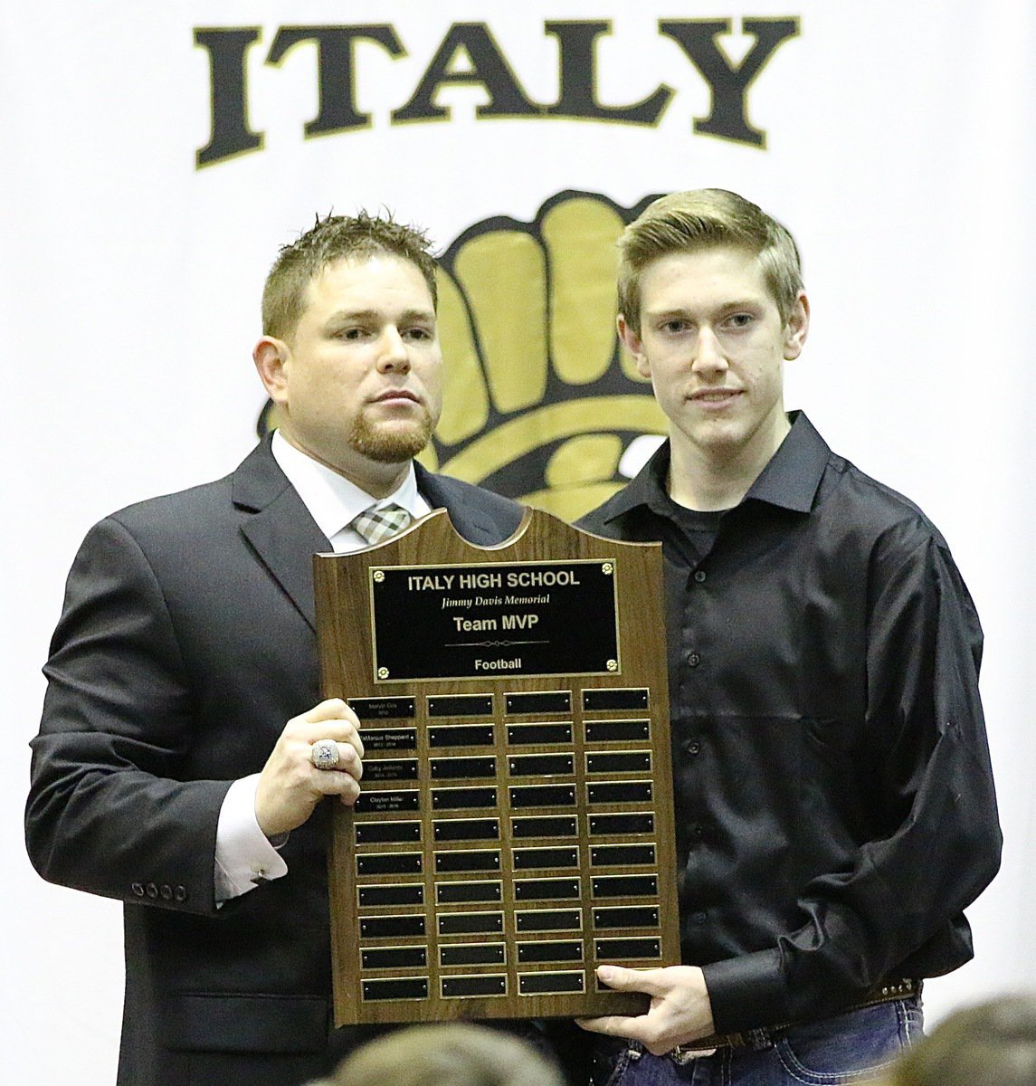 Image: Coach David Weaver present senior Clayton Miller with the Italy Gladiator Football, Jimmy Davis Memorial Team MVP Award.