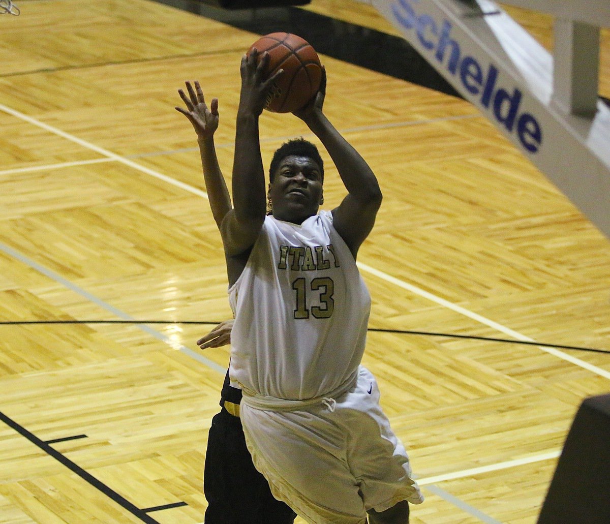 Image: Christion Washington(13) takes the hit from an Itasca defender while scoring a basket for the Italy JV Gladiators.