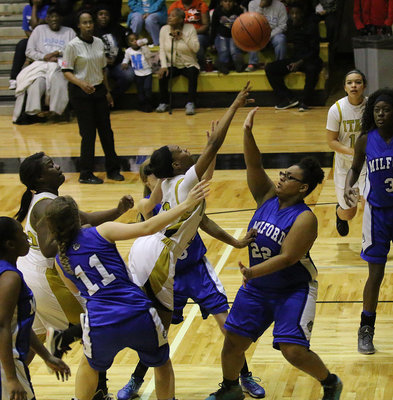 Image: Italy’s Decorea Green(13) powers her way into the lane to draw a shooting foul.