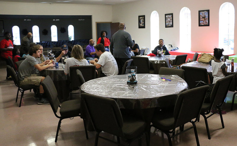 Image: After the judging, everyone settles in to sample the different types of chili.