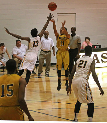 Image: Keith Davis, II (11) starts the game off with a three-point bomb for the Gladiators.