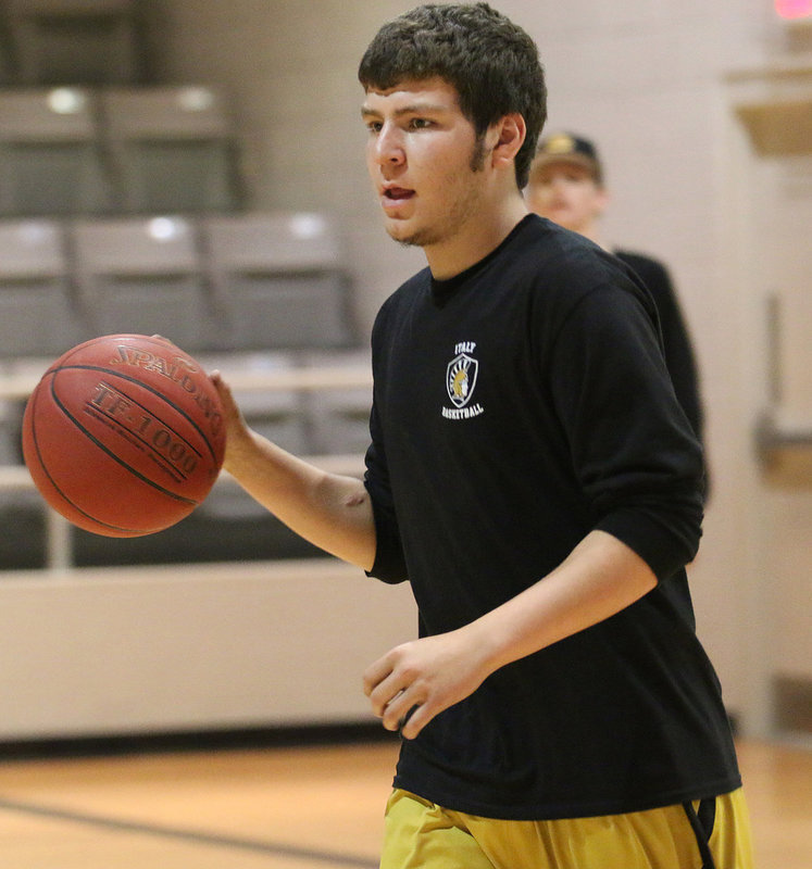 Image: Micah Escamilla gets game ready during warmups against Itasca.