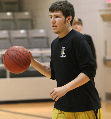 Image: Micah Escamilla gets game ready during warmups against Itasca.