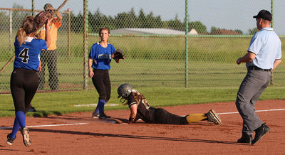 Image: Lady Gladiator Brycelen Richards(17) slides safely into third-base.