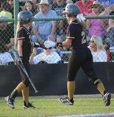 Image: Italy Lady Gladiator Brooke DeBorde(2) scores and gets congratulated by senior Britney Chambers(4).