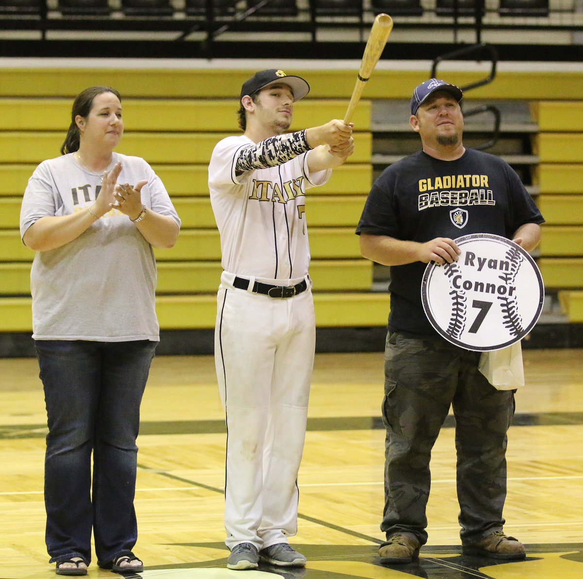 Image: Senior Italy Gladiator Baseball member Ryan Connor(7) is escorted by his parents, Amanda and Scott Connor for Senior Night during a post-game ceremony.