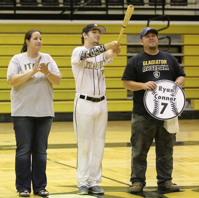 Image: Senior Italy Gladiator Baseball member Ryan Connor(7) is escorted by his parents, Amanda and Scott Connor for Senior Night during a post-game ceremony.