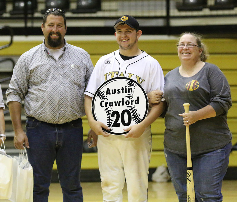 Image: Senior Italy Gladiator Baseball member Ty Windham(12) is escorted by his parents, Heidi and Phillip Crawford, for Senior Night during a post-game ceremony.