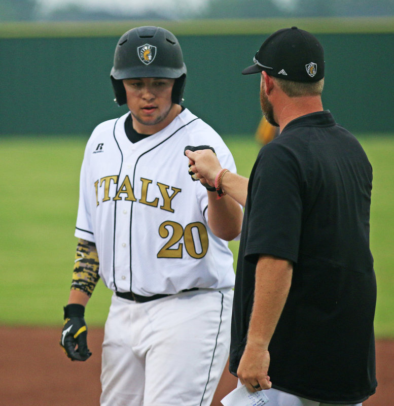 Image: Austin Crawford(20) receives that symbolic fist bump from assistant coach Mitchell Blake for a job well done after his team rallying single.